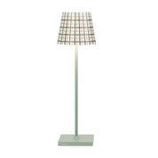 Floor lamp with a plaid shade on a white background